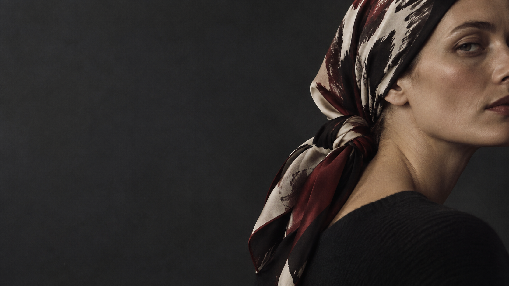 Custom printed silk headscarf in a dark luxury fashion editorial setting
